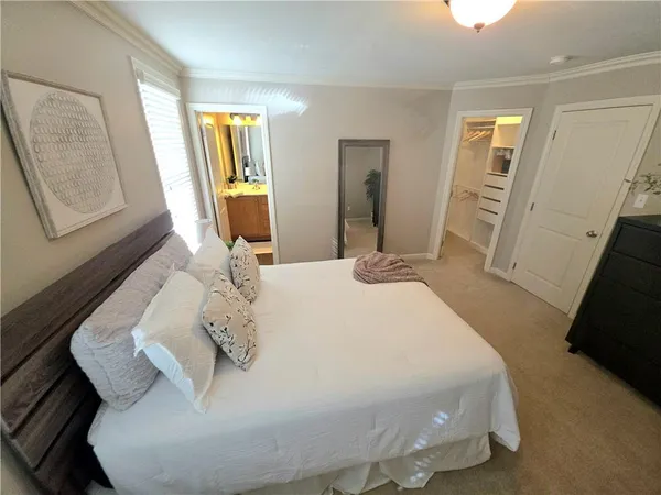 a bedroom with a bed and a mirror