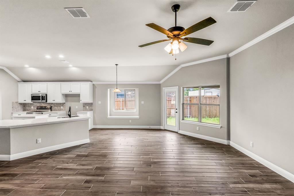 314 Pennington Road Josephine, TX 75173 - Photo 25 of 37 a view of a kitchen with microwave and wooden floor