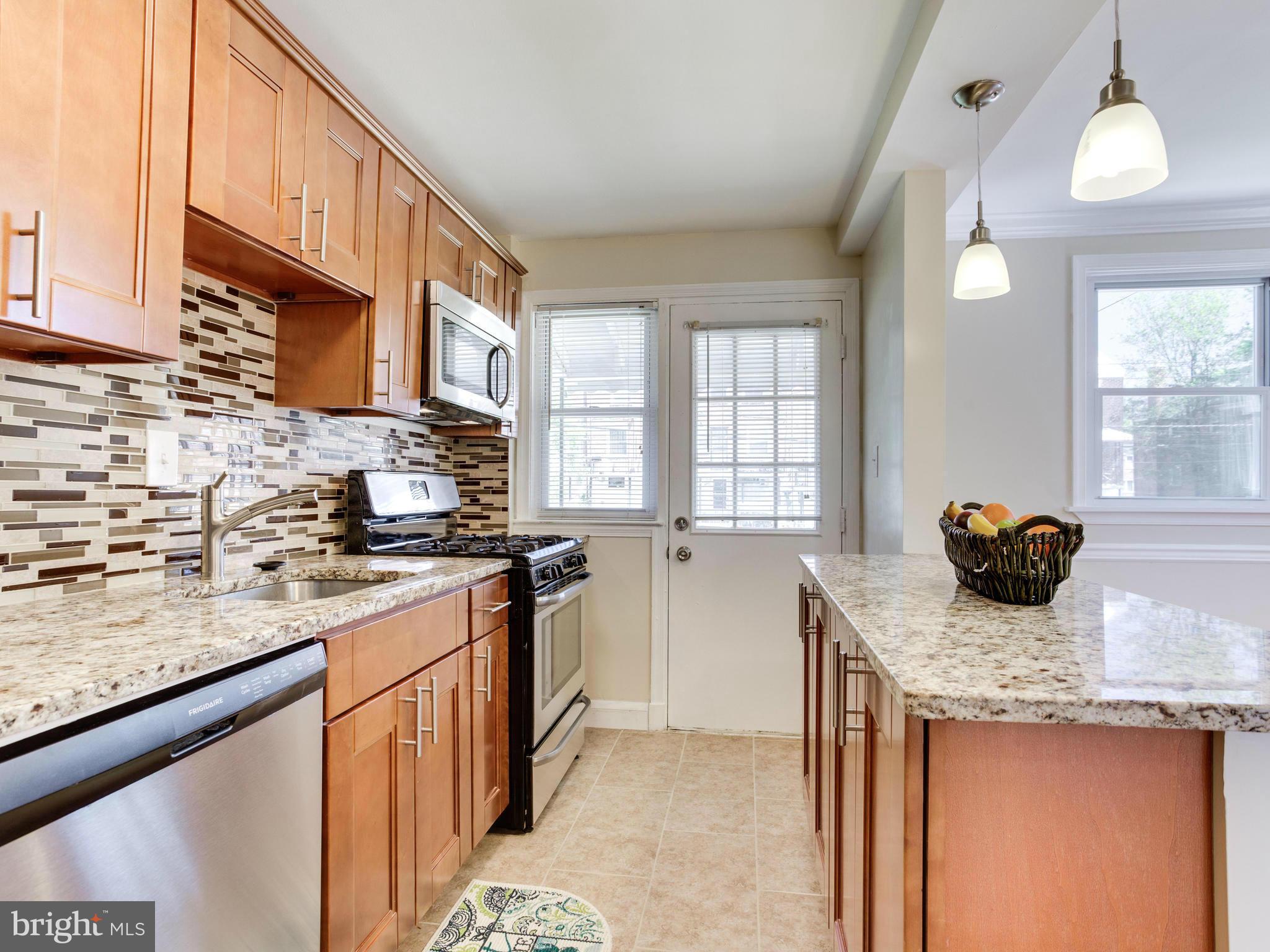 4400 Eldone Road Baltimore, MD 21229 - Photo 1 of 30 a kitchen with stainless steel appliances granite countertop a sink stove and cabinets