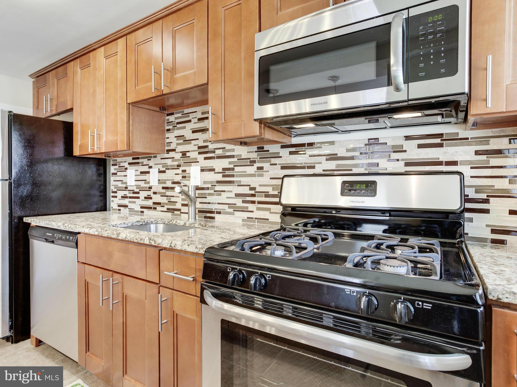 4400 Eldone Road Baltimore, MD 21229 - Photo 14 of 30 a stove top oven sitting inside of a kitchen