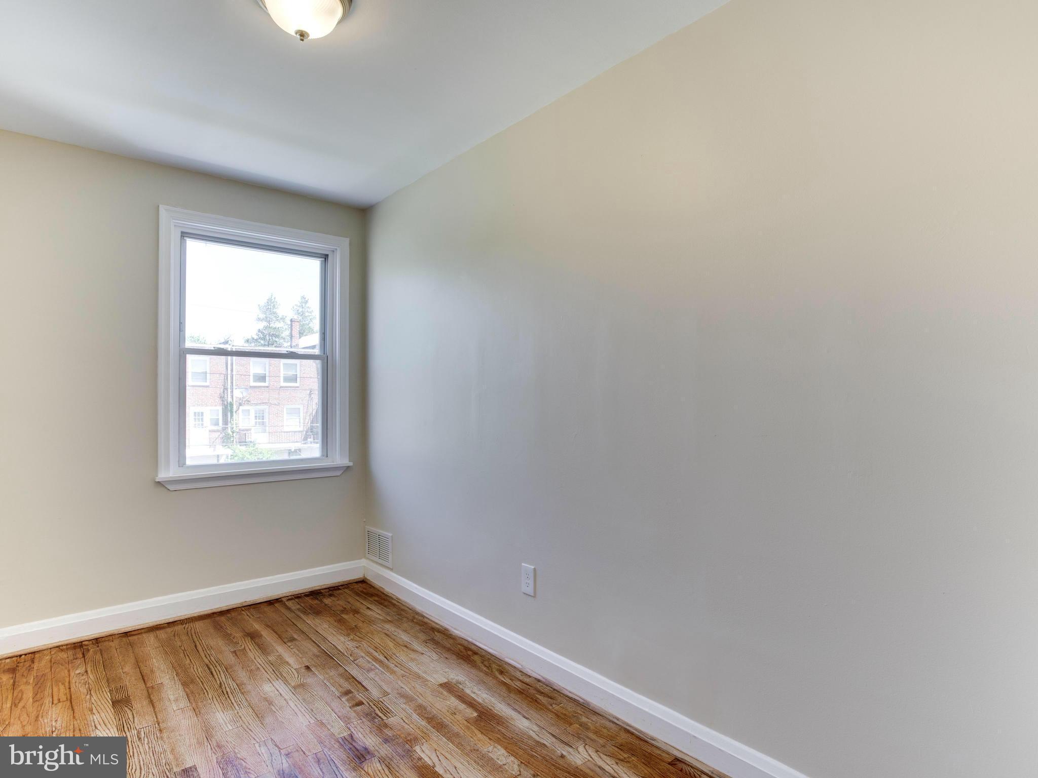 4400 Eldone Road Baltimore, MD 21229 - Photo 15 of 30 an empty room with wooden floor and windows