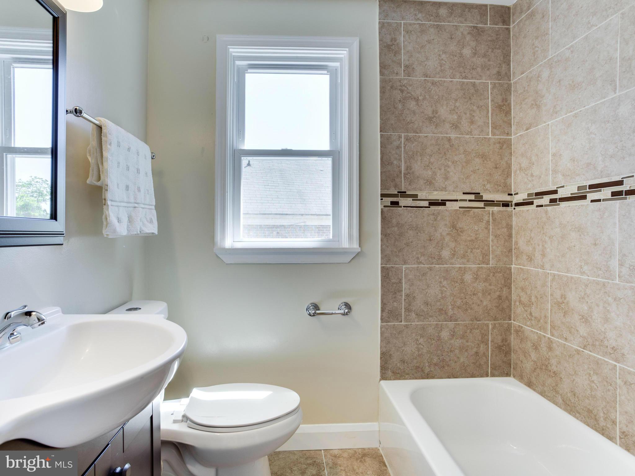 4400 Eldone Road Baltimore, MD 21229 - Photo 18 of 30 a bath room with a toilet a sink and a bath tub
