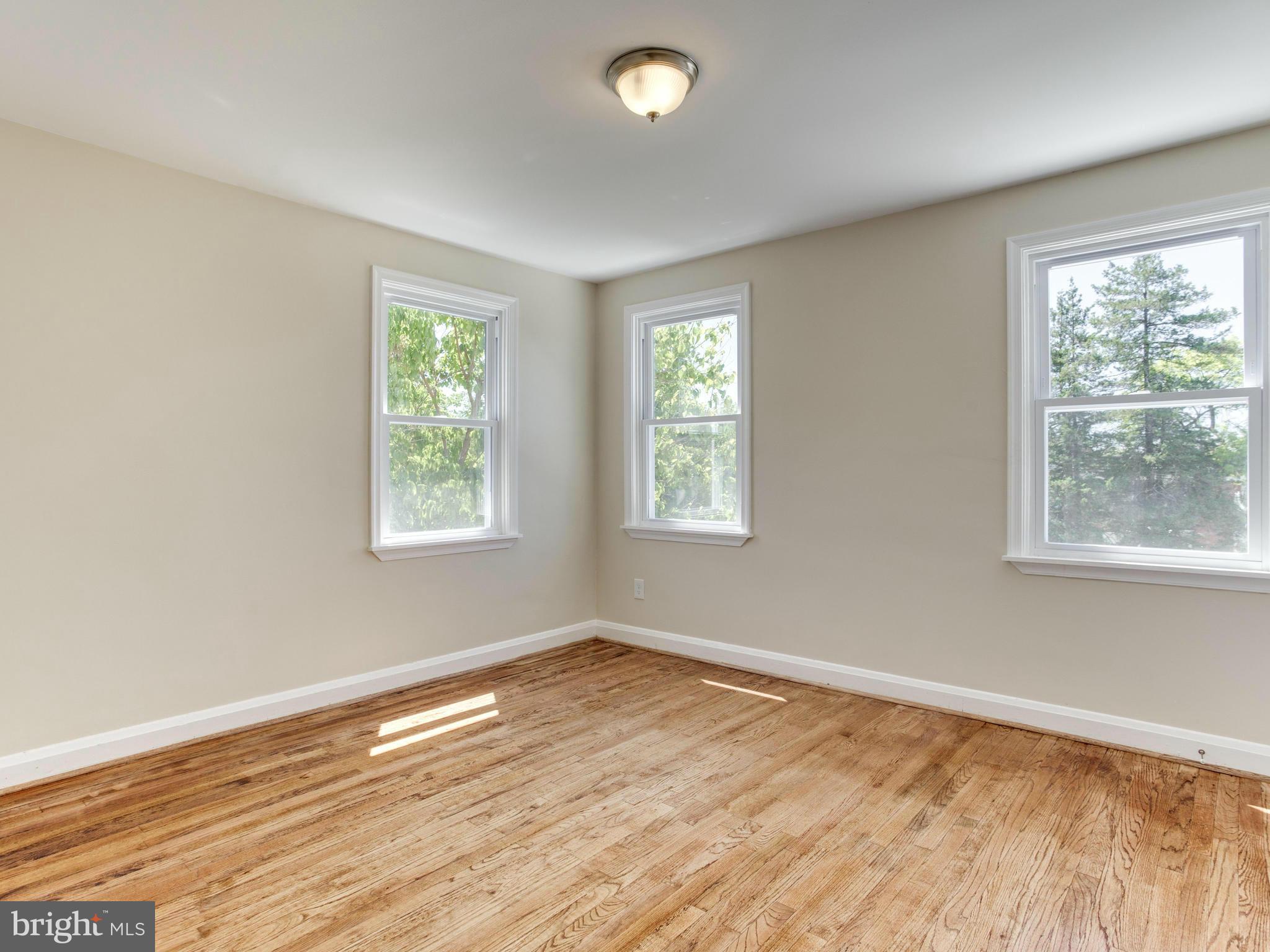 4400 Eldone Road Baltimore, MD 21229 - Photo 19 of 30 a view of an empty room with wooden floor and a window