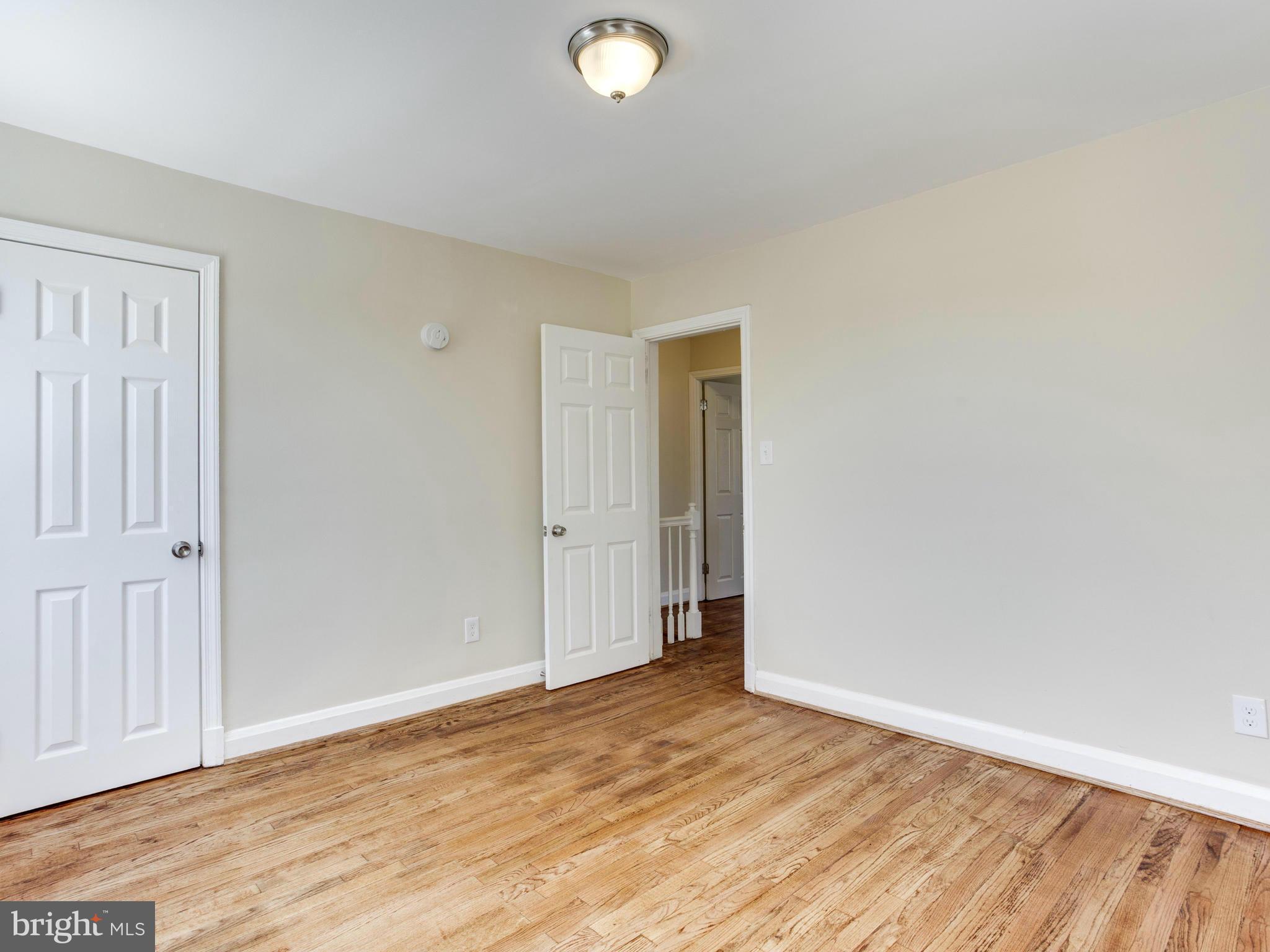 4400 Eldone Road Baltimore, MD 21229 - Photo 20 of 30 a view of an empty room with wooden floor and closet