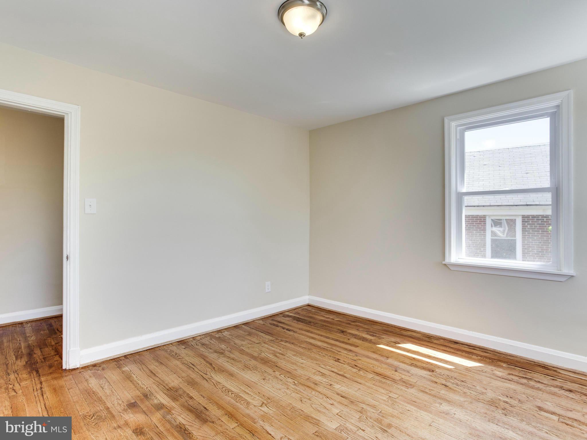 4400 Eldone Road Baltimore, MD 21229 - Photo 21 of 30 a view of empty room with wooden floor and fan