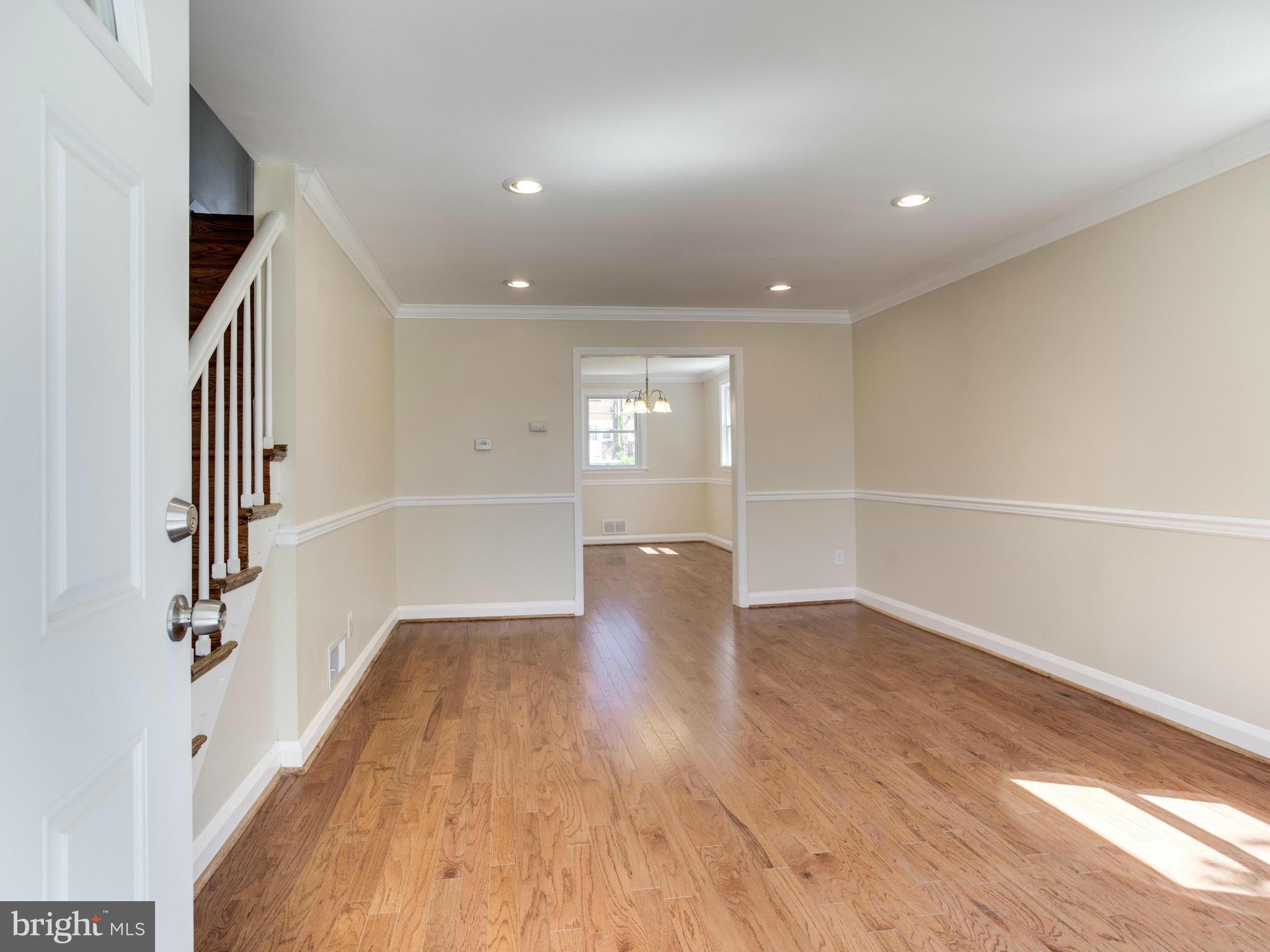4400 Eldone Road Baltimore, MD 21229 - Photo 5 of 30 a view of an empty room with wooden floor and a window