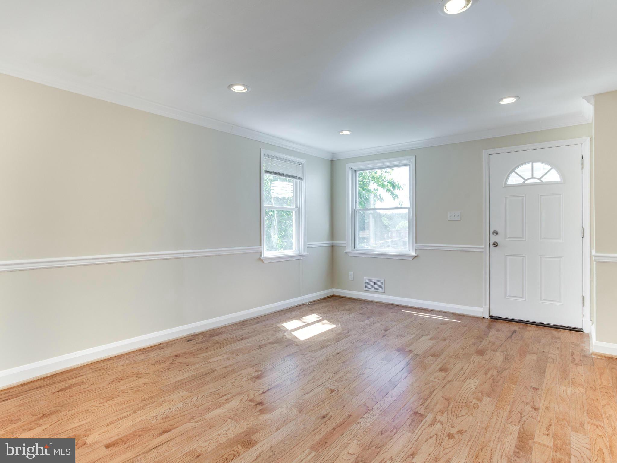 4400 Eldone Road Baltimore, MD 21229 - Photo 6 of 30 an empty room with wooden floor and windows