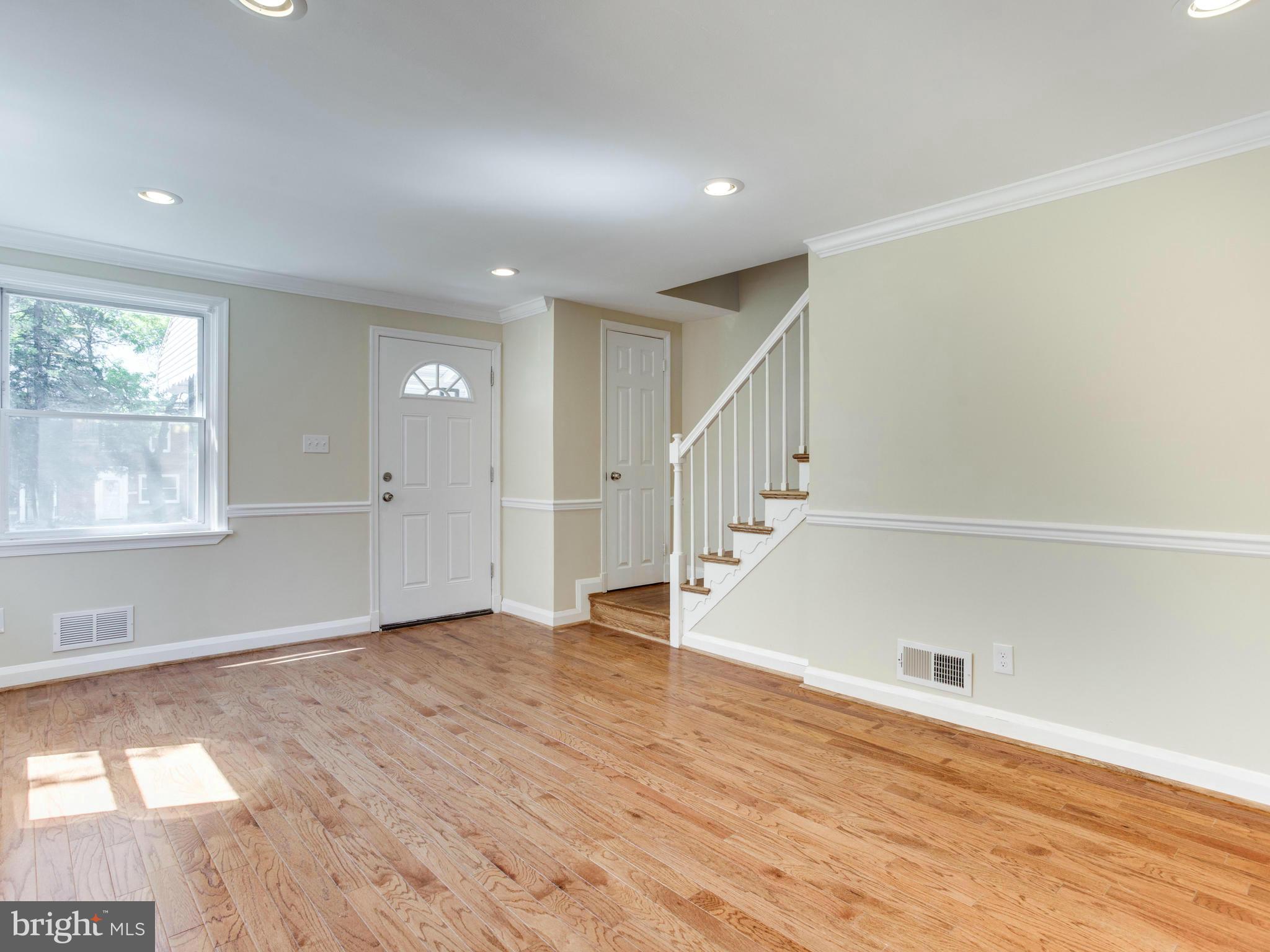 4400 Eldone Road Baltimore, MD 21229 - Photo 7 of 30 a view of an empty room with wooden floor and a window