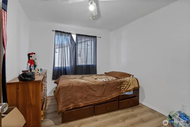 a bed sitting in a bedroom next to a window
