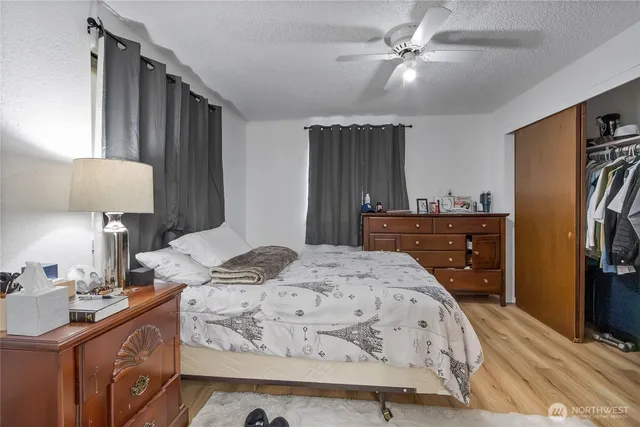 a bed room with a bed mirror and a lamp