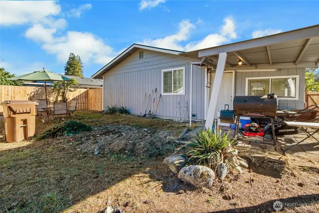 a view of a house with yard and sitting area