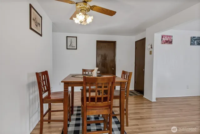 a view of a dining room with furniture and wooden floor