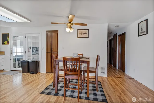 a view of a dining room with furniture and wooden floor