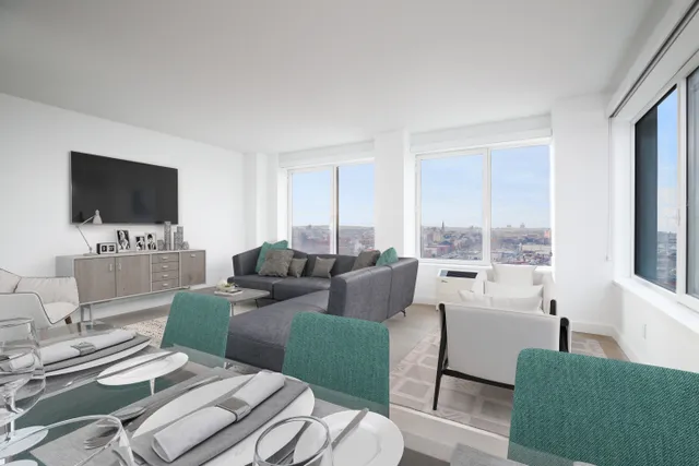 a living room with furniture a flat screen tv and a large window