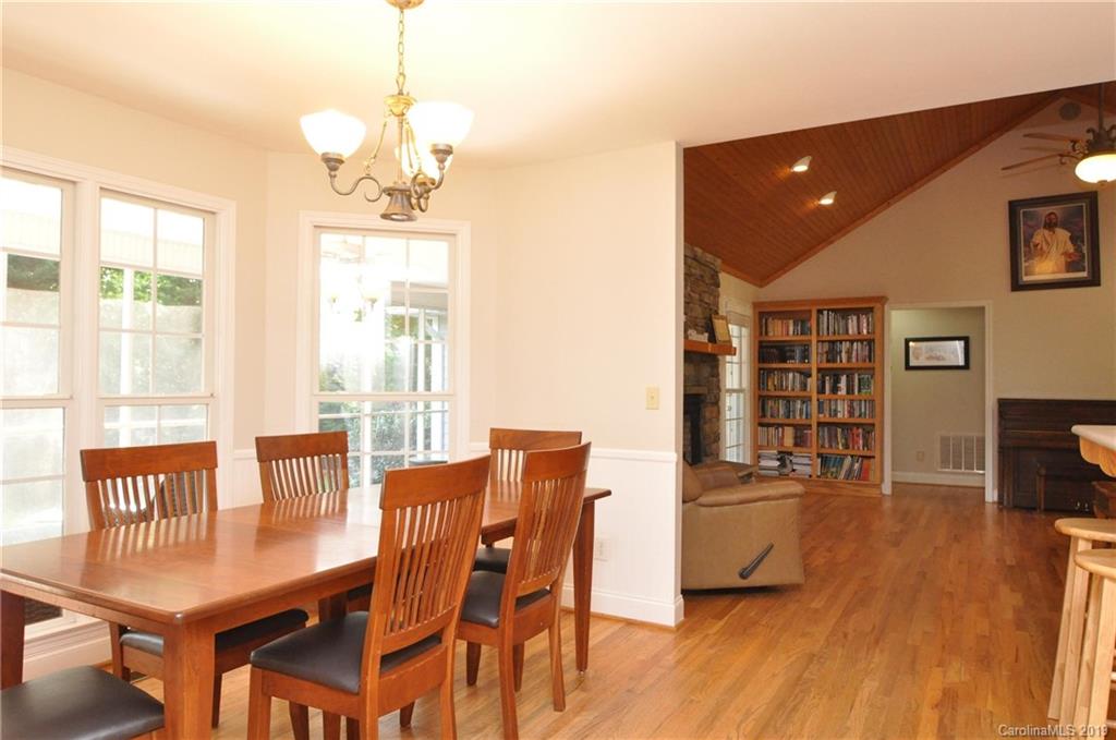 2346 Manus Chapel Road Mill Spring, NC 28756 - Photo 14 of 33 a view of a dining room with furniture window and wooden floor