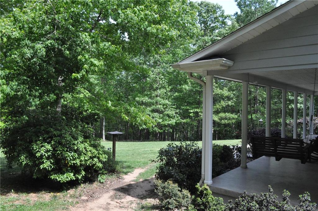 2346 Manus Chapel Road Mill Spring, NC 28756 - Photo 5 of 33 a view of a patio with a table chairs and a backyard