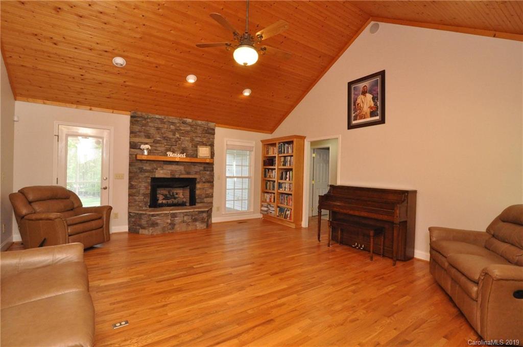 2346 Manus Chapel Road Mill Spring, NC 28756 - Photo 8 of 33 a living room with furniture and a fireplace