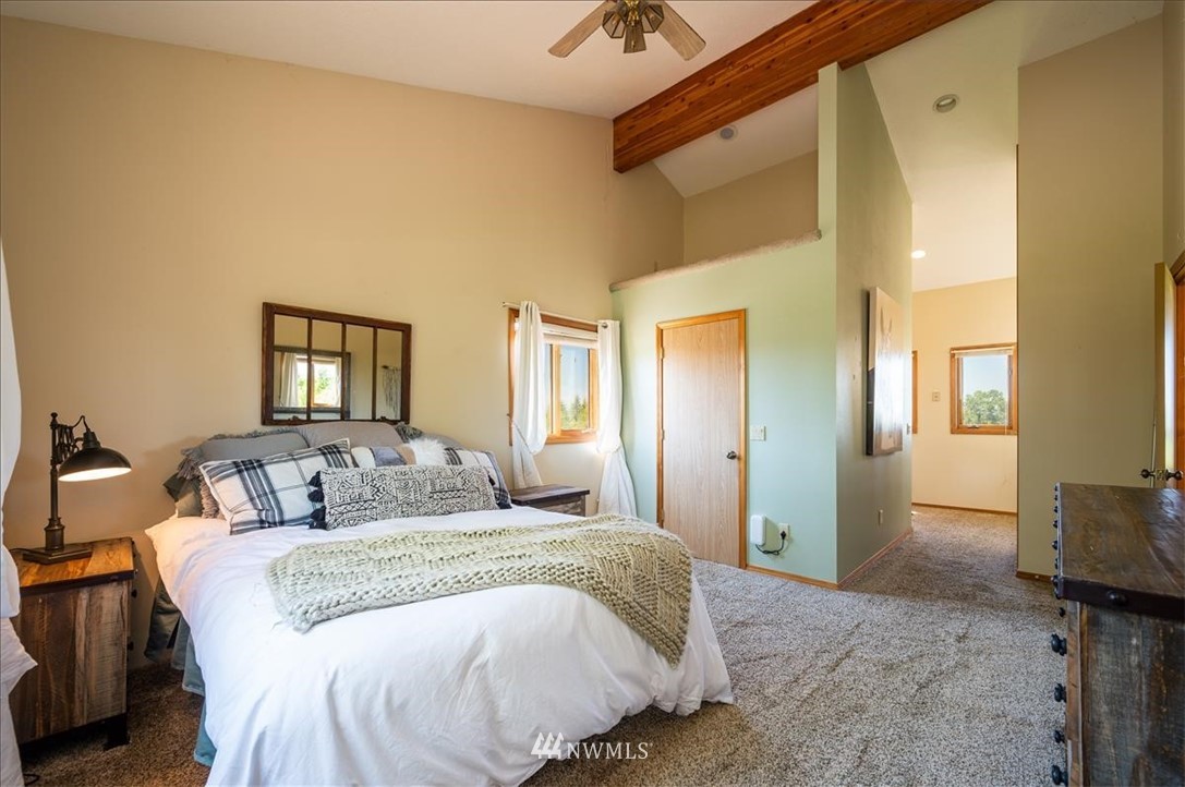 320 East Axton Road Bellingham, WA 98226 - Photo 14 of 40 a bedroom with a bed and a chandelier
