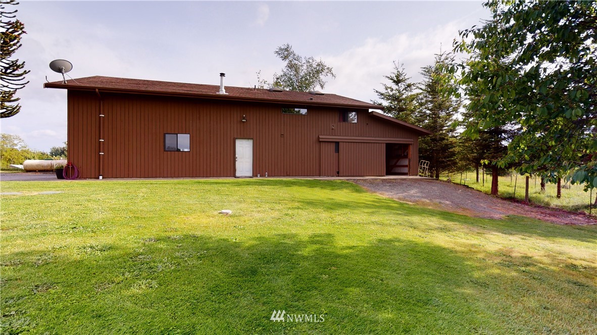 320 East Axton Road Bellingham, WA 98226 - Photo 29 of 40 a front view of a house with yard and trees