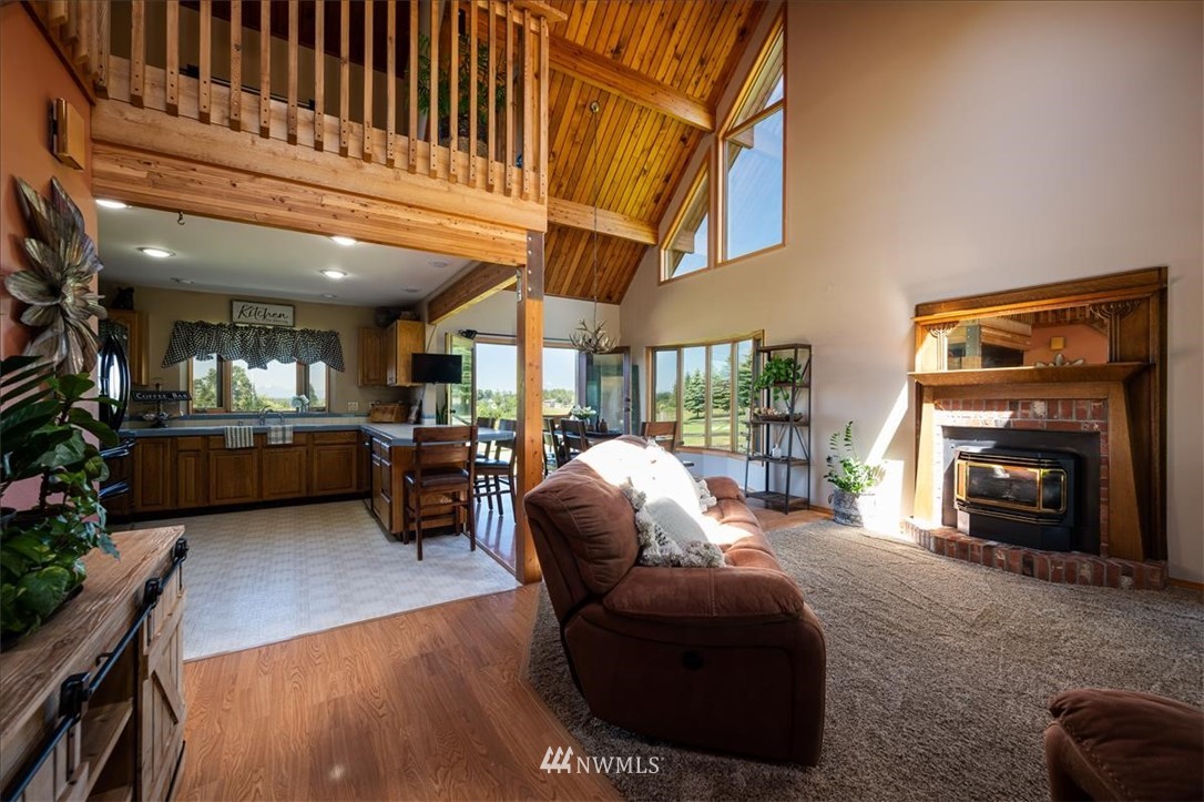 320 East Axton Road Bellingham, WA 98226 - Photo 8 of 40 a living room with furniture a fireplace and a floor to ceiling window