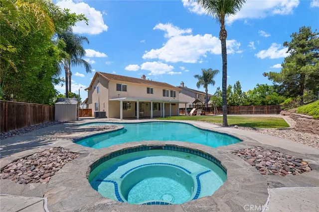 a swimming pool with outdoor seating and yard