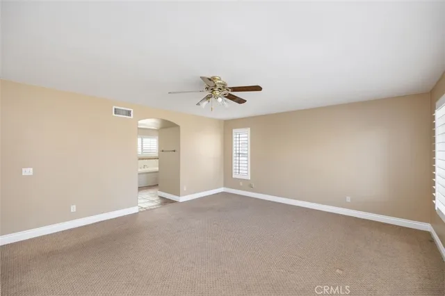 a view of a livingroom with a ceiling fan and window