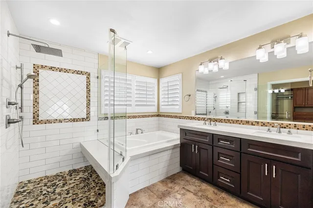 a spacious bathroom with a tub sink and mirror