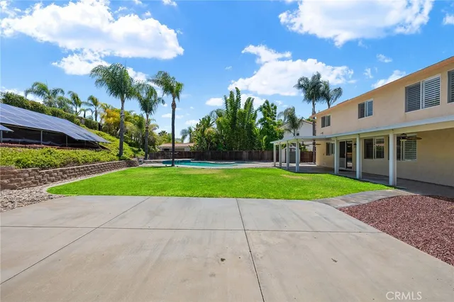 a view of a house with a big yard and potted plants