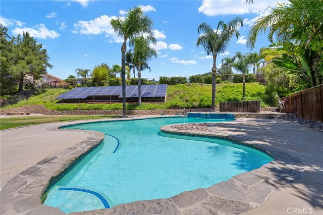 a view of a swimming pool with a yard