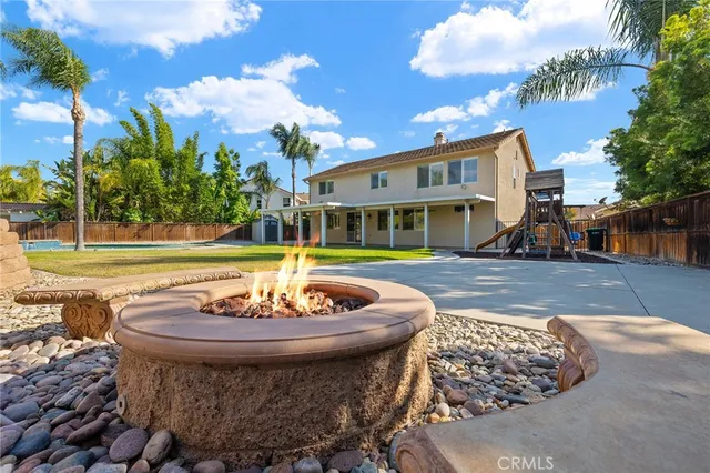 a view of a house with a swimming pool and a sitting area