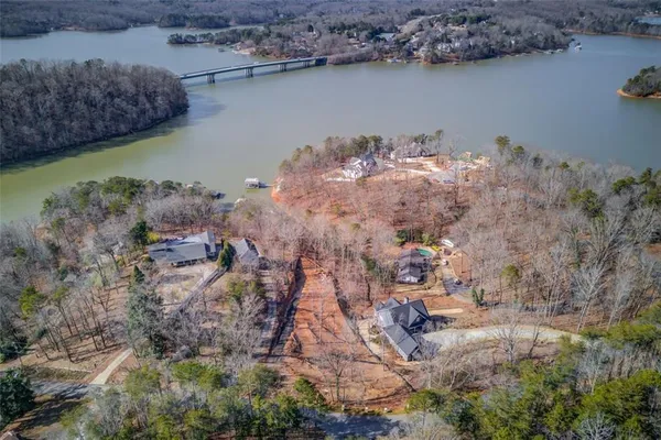 a aerial view of a house with a yard and lake view