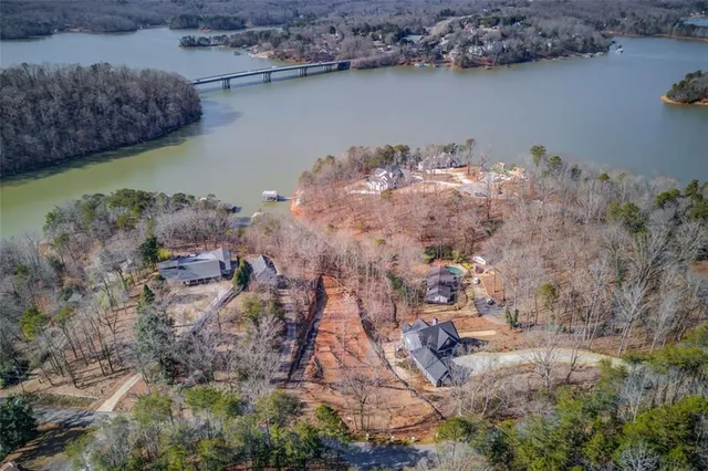 a aerial view of a house with a yard and lake view