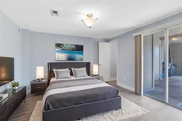 a bedroom with a bed and a chandelier