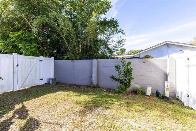 a front view of a house with a yard and a garden