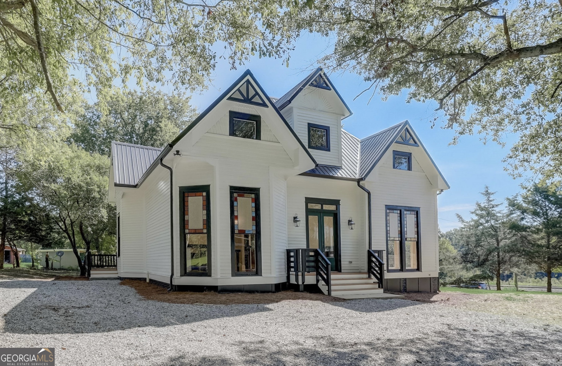 a front view of a house with a tree