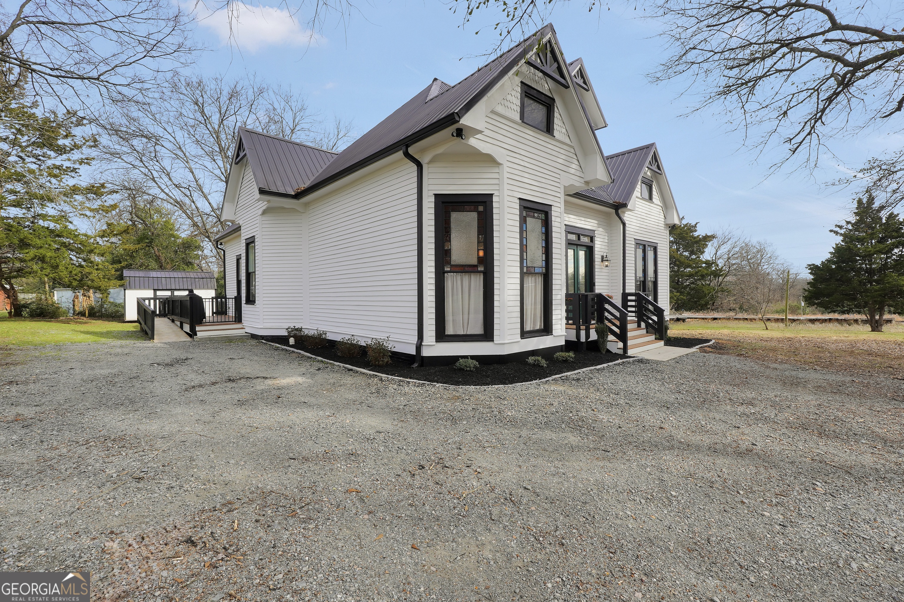 263 Julia Street Monticello, GA 31064 - Photo 3 of 49 a view of a house with a yard and garage