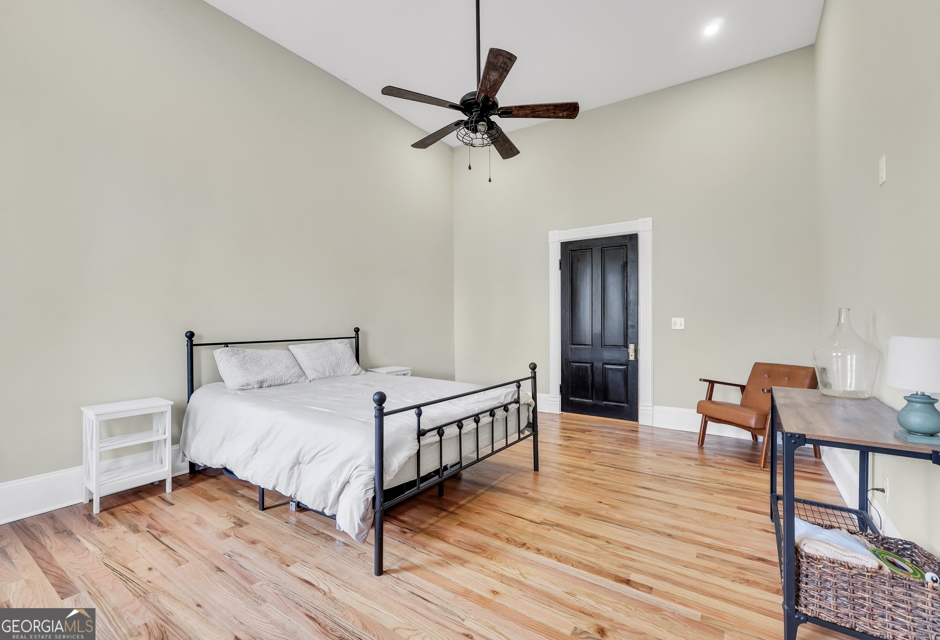 263 Julia Street Monticello, GA 31064 - Photo 38 of 49 a bedroom with a bed and wooden floor