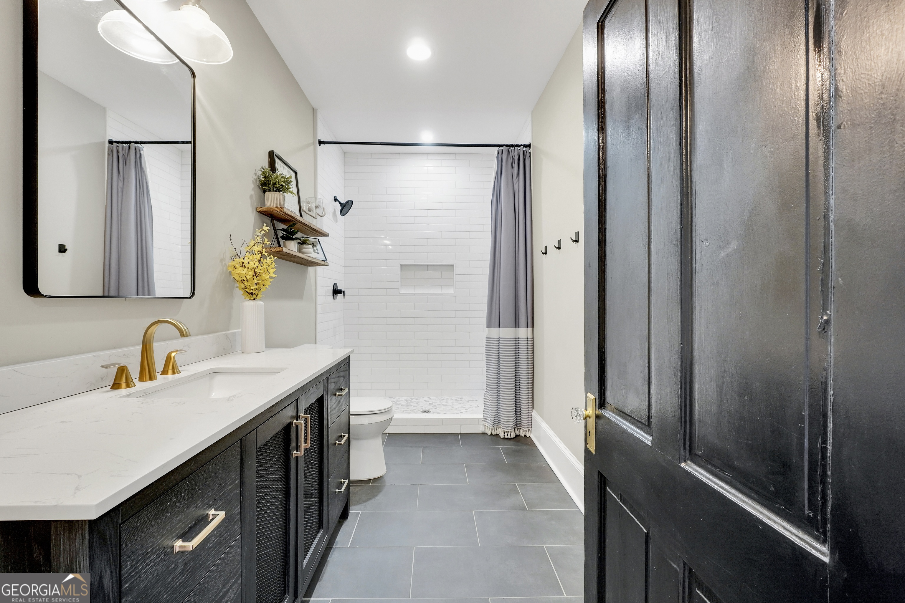 263 Julia Street Monticello, GA 31064 - Photo 42 of 49 a bathroom with a sink and a mirror