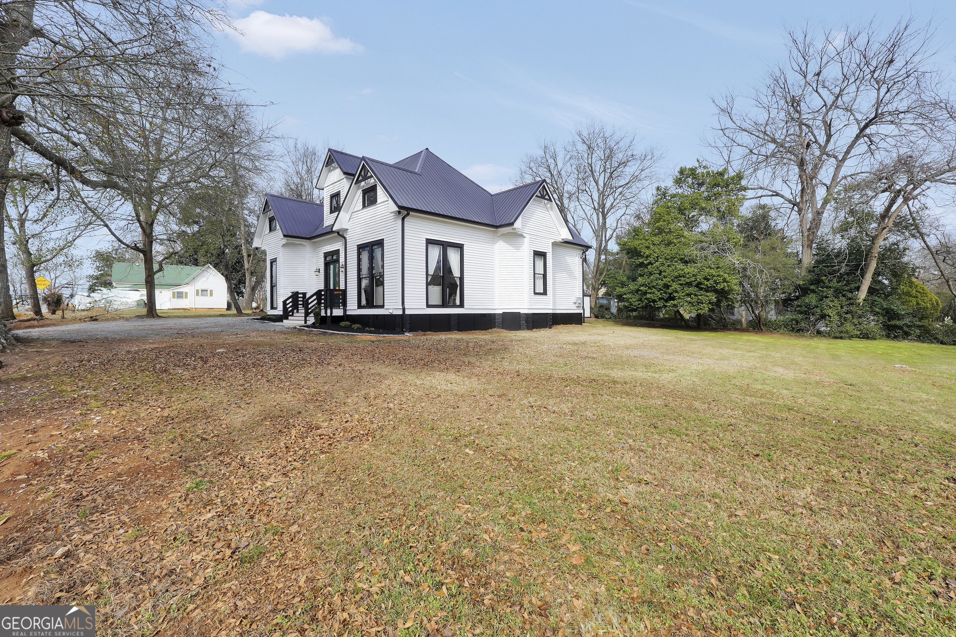263 Julia Street Monticello, GA 31064 - Photo 5 of 49 a view of a house with a yard and garage