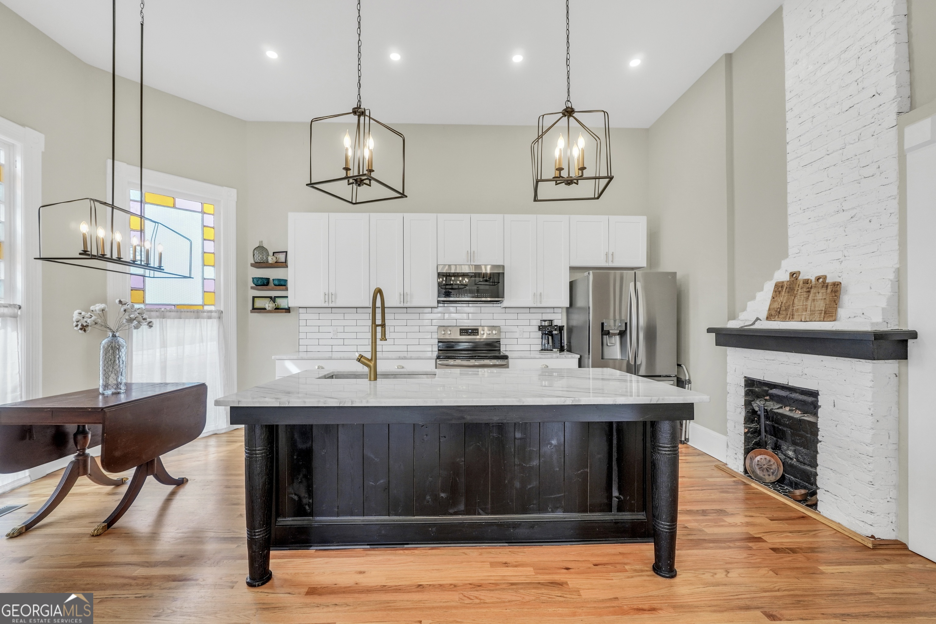 263 Julia Street Monticello, GA 31064 - Photo 9 of 49 a kitchen with kitchen island stainless steel appliances a dining table and chairs