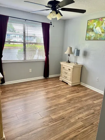 a room with a window and ceiling fan