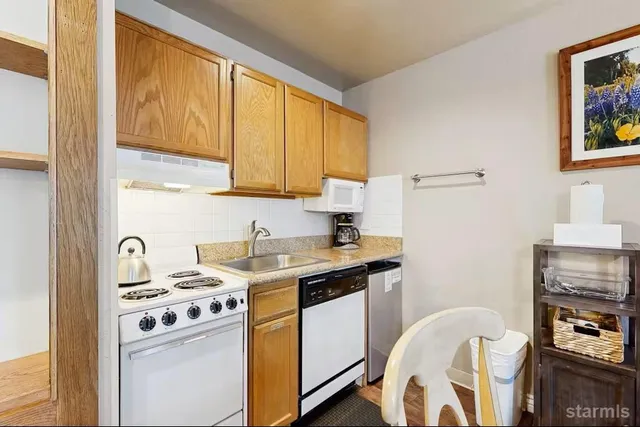 a view of a kitchen with sink and electronic appliances