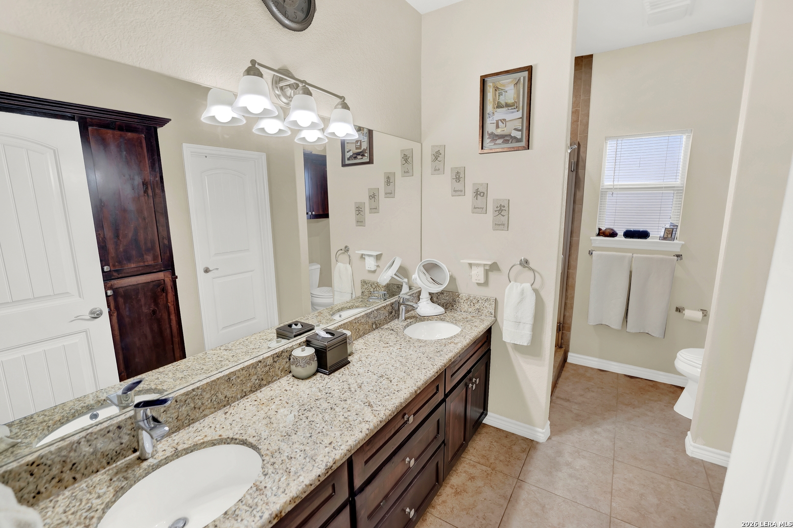 11669 Flores Avenue LaCoste, TX 78039 - Photo 16 of 36 a bathroom with a granite countertop sink a mirror and a shower