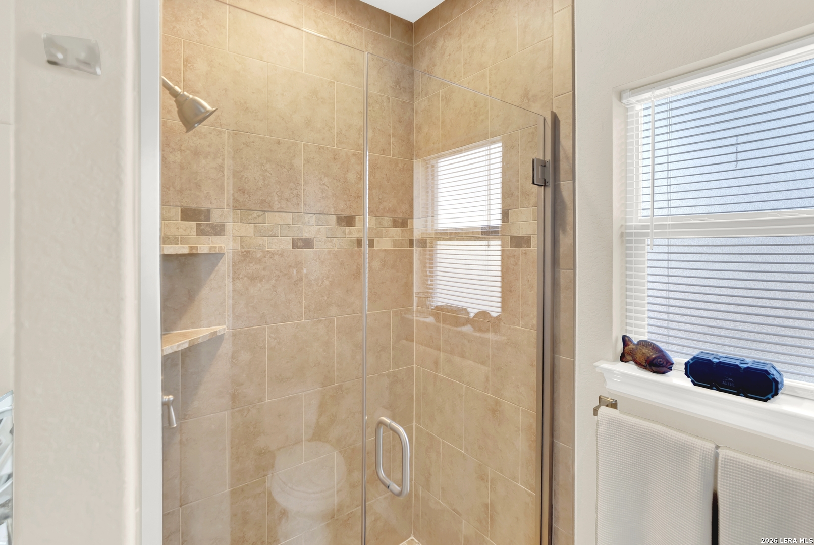 11669 Flores Avenue LaCoste, TX 78039 - Photo 17 of 36 a bathroom with a shower and a window