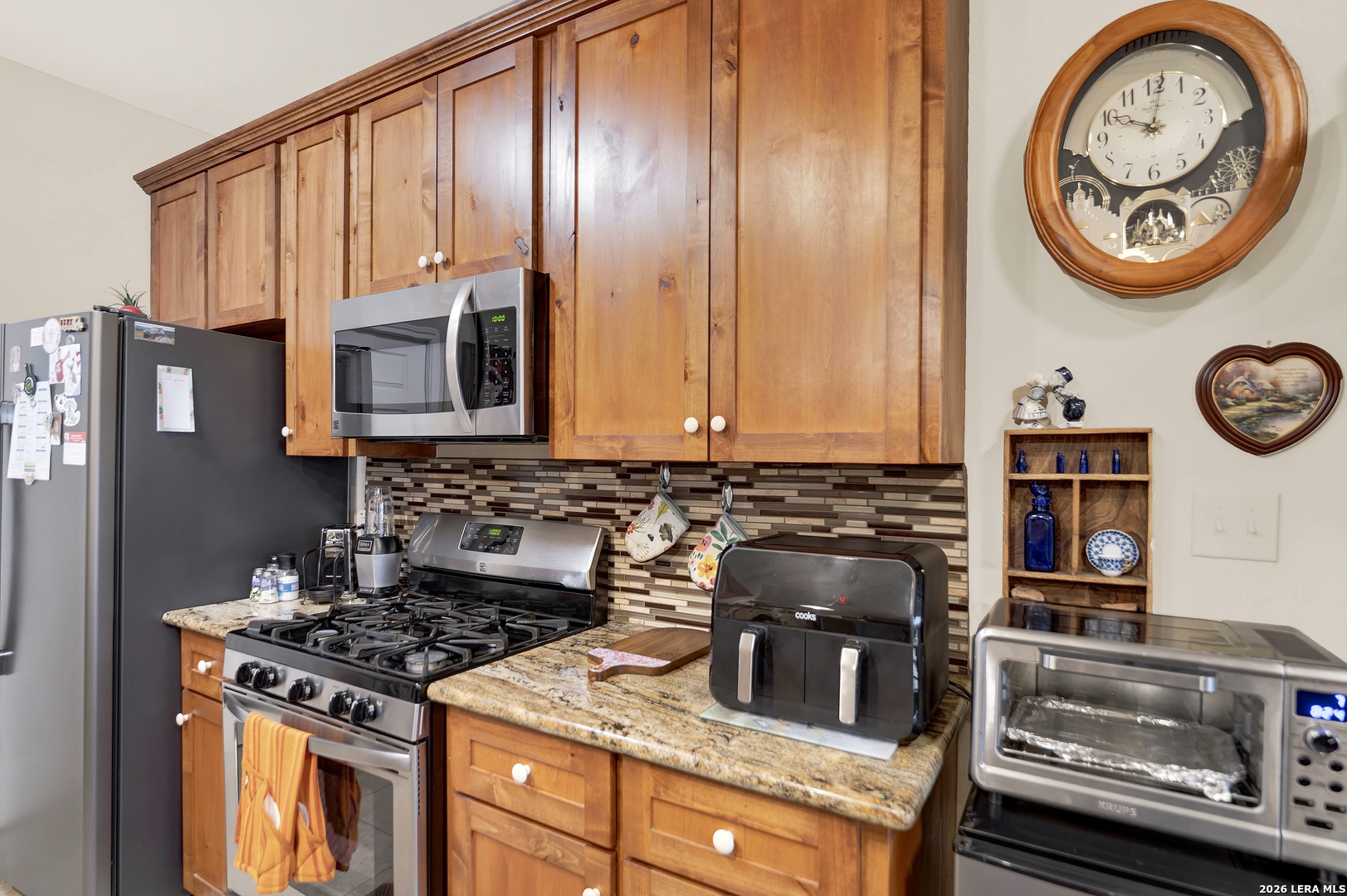 11669 Flores Avenue LaCoste, TX 78039 - Photo 23 of 36 a kitchen with a stove and a clock