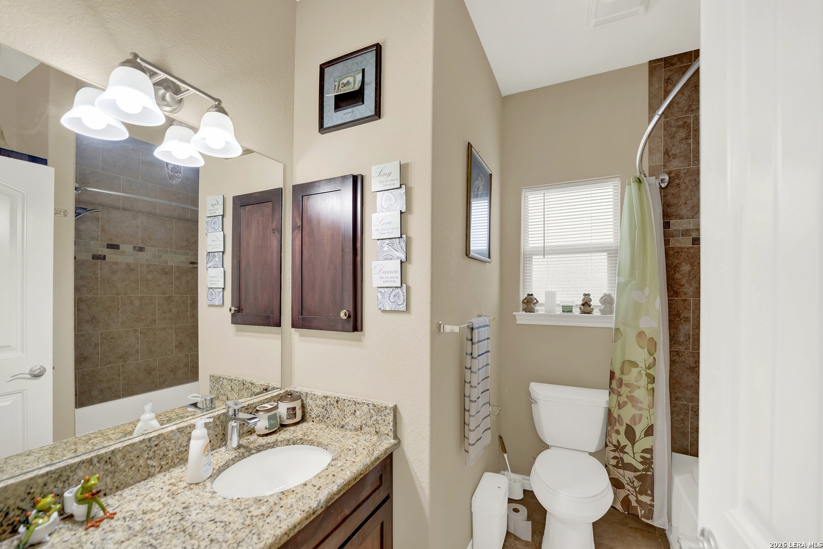 11669 Flores Avenue LaCoste, TX 78039 - Photo 10 of 36 a bathroom with a sink a toilet and a mirror