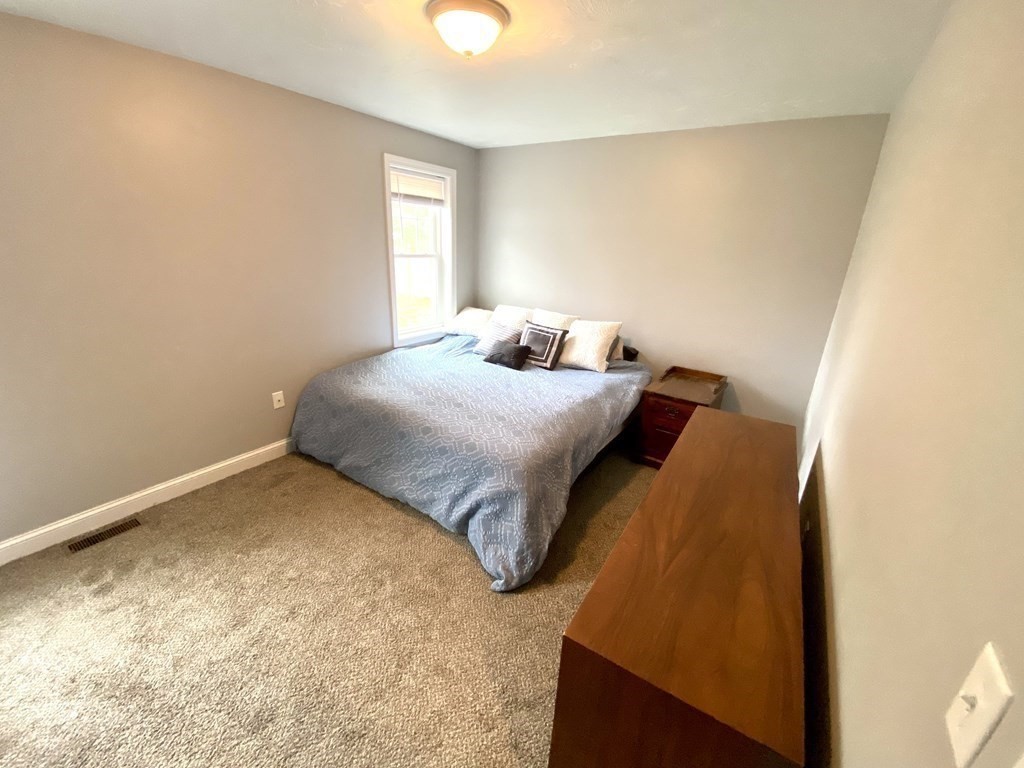 8 Mill Street, Unit B Wareham, MA 02576 - Photo 11 of 30 a bedroom with a bed and a window
