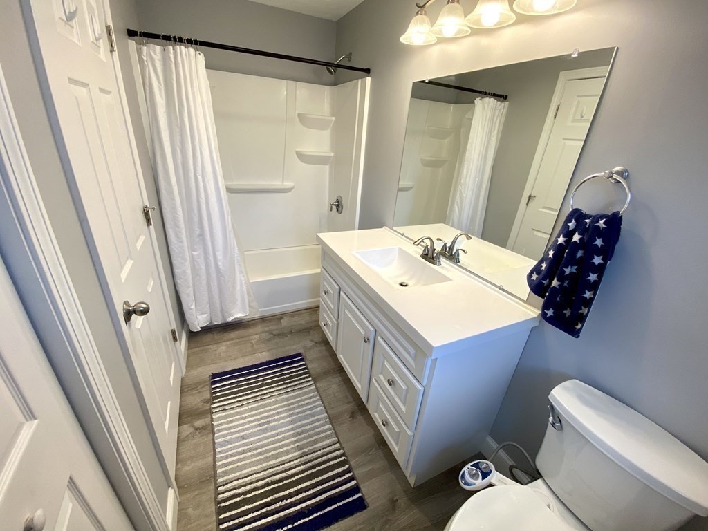 8 Mill Street, Unit B Wareham, MA 02576 - Photo 12 of 30 a bathroom with a sink a toilet a mirror and shower