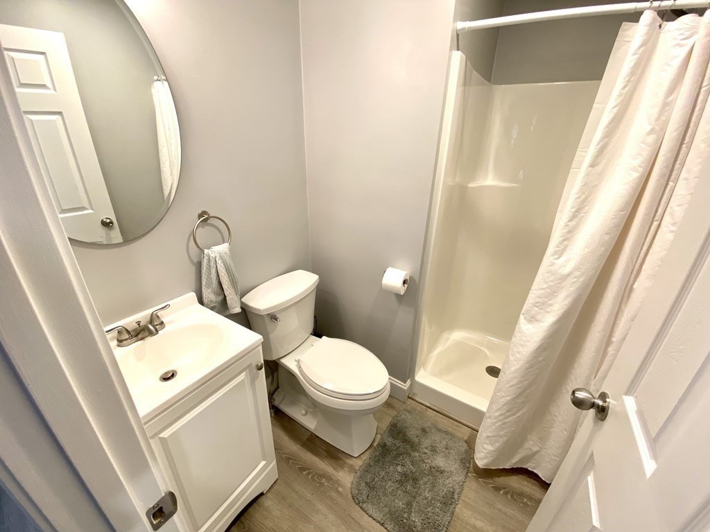 8 Mill Street, Unit B Wareham, MA 02576 - Photo 19 of 30 a white toilet sitting next to a bathroom sink