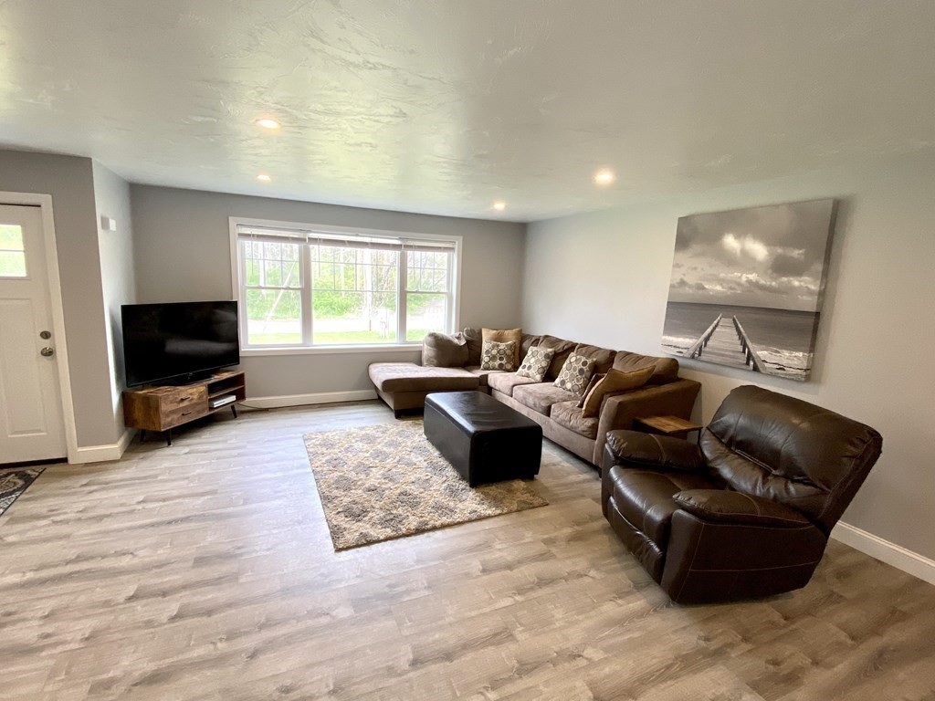 8 Mill Street, Unit B Wareham, MA 02576 - Photo 5 of 30 a living room with furniture and a flat screen tv